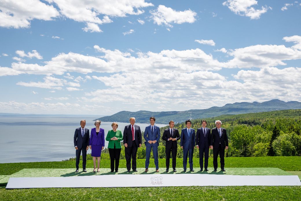 Leaders at the 2018 G7 Summit in Charlevoix, Quebec. Left to right: Donald Tusk, Theresa May, Angela Merkel, Donald Trump, Justin Trudeau, Emmanuel Macron, Shinzo Abe, Giuseppe Conte, Jean-Claude Juncker